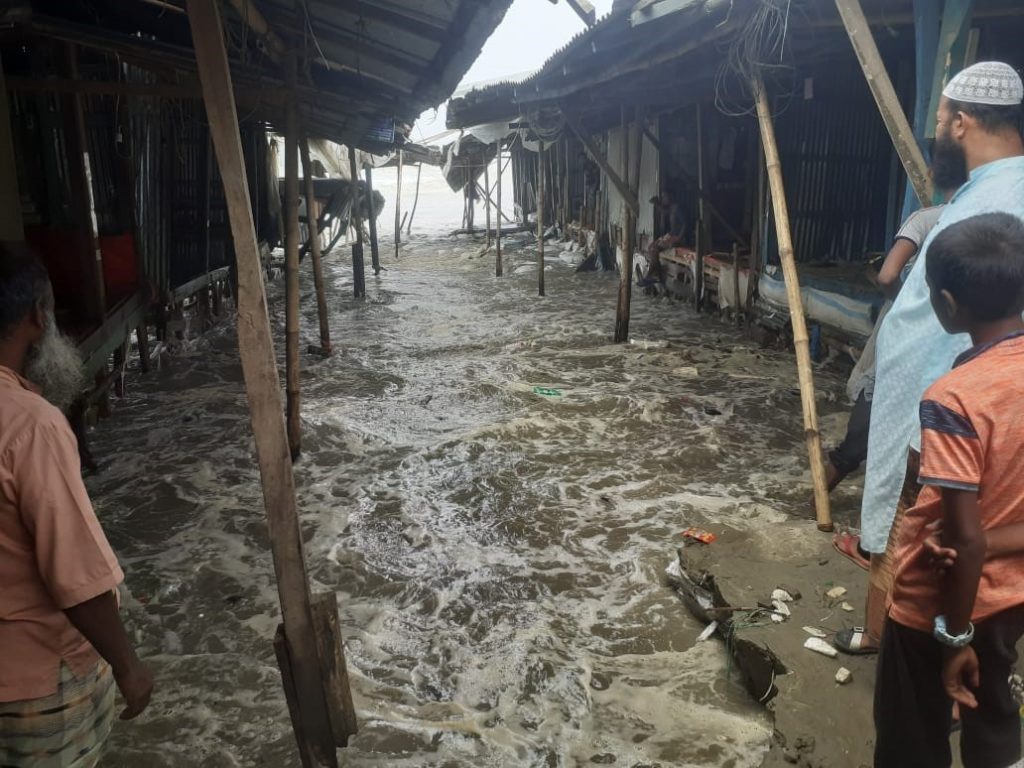 Villagers look on helplessly as brackish water floods their bazaar. © A J GHANI - Cyclone Yaas