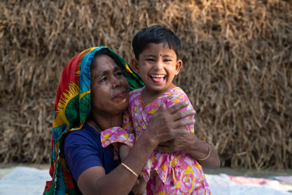 Sumaya a girl with disability in rural Bangladesh, poses with her mother