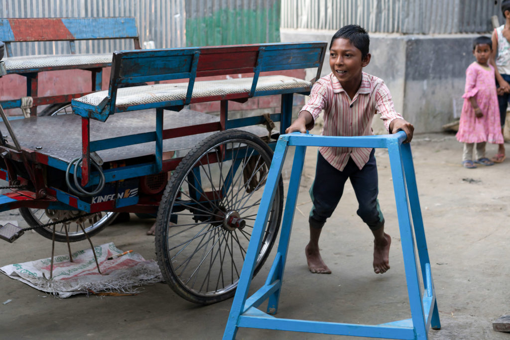 Tawhid, a rural Bangladeshi boy with disability, with his walker